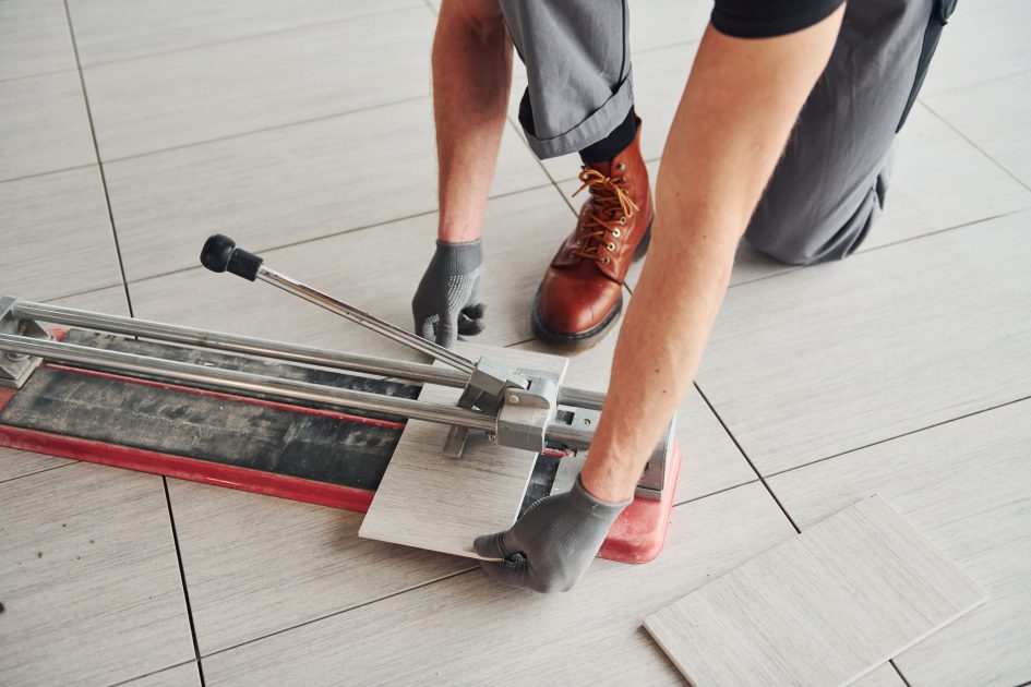 man-grey-uniform-installing-plate-indoors-modern-big-office-daytime